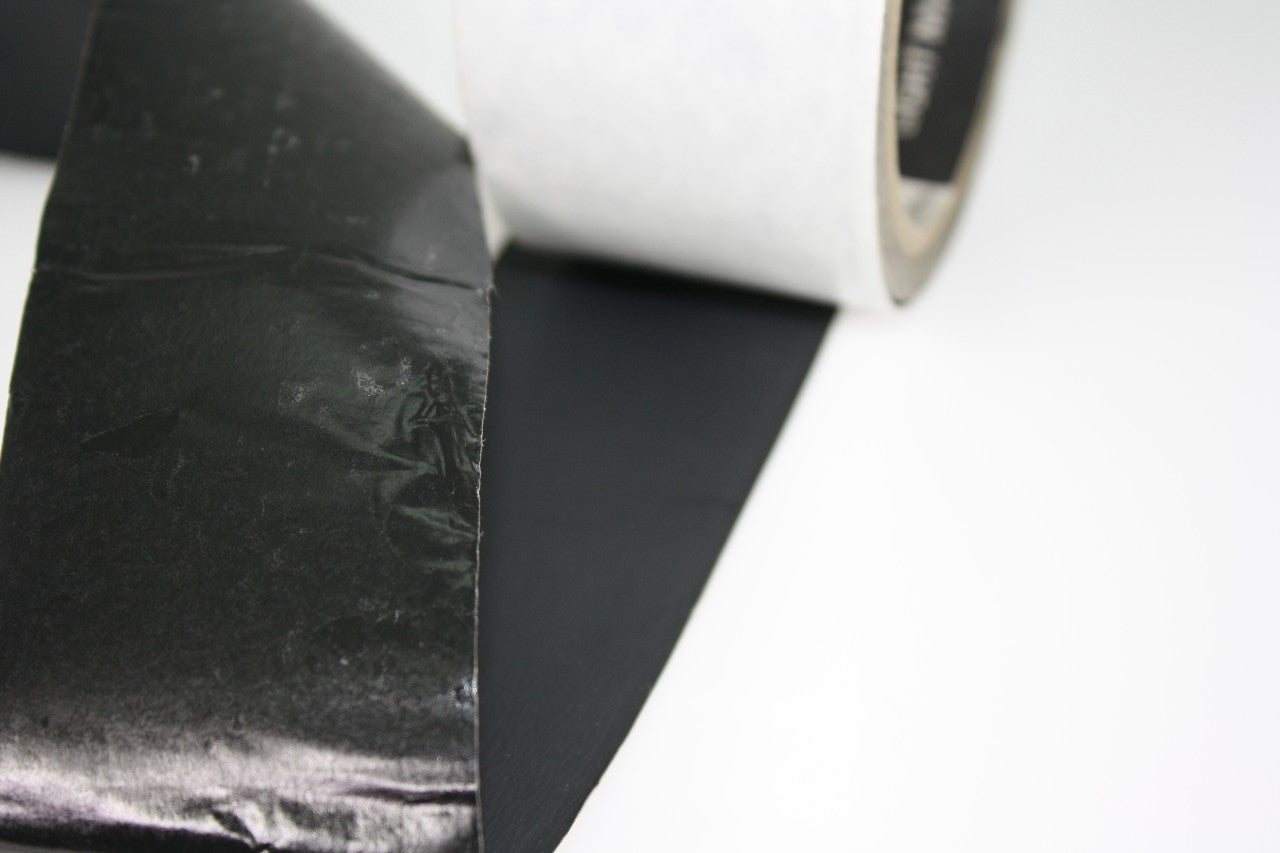 A close up of the tape showing the adhesive underside and the matte black foil