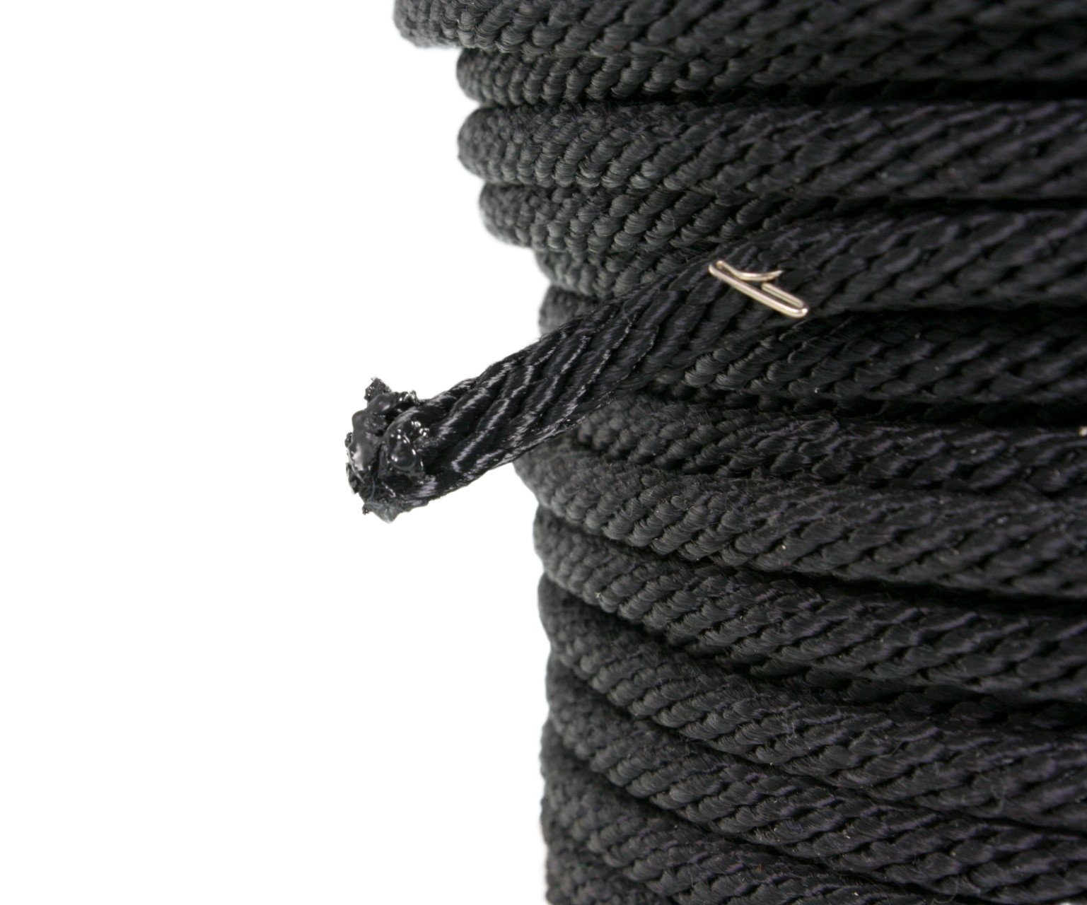 End of a roll of black sash cord, showing that the tail of it has been burned to seal the fibres.