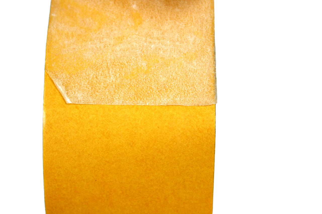 A close up of the tape on the roll. The protective laminate has been peeled away to show the tape underneath