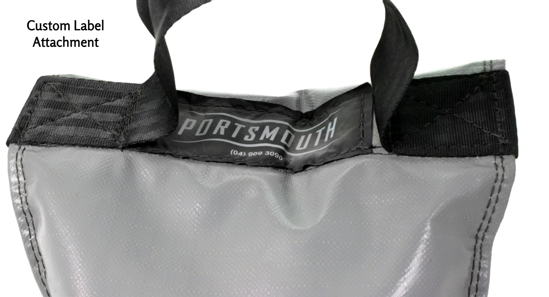 A custom label attachment, at the top of the sandbag, between the handle anchors