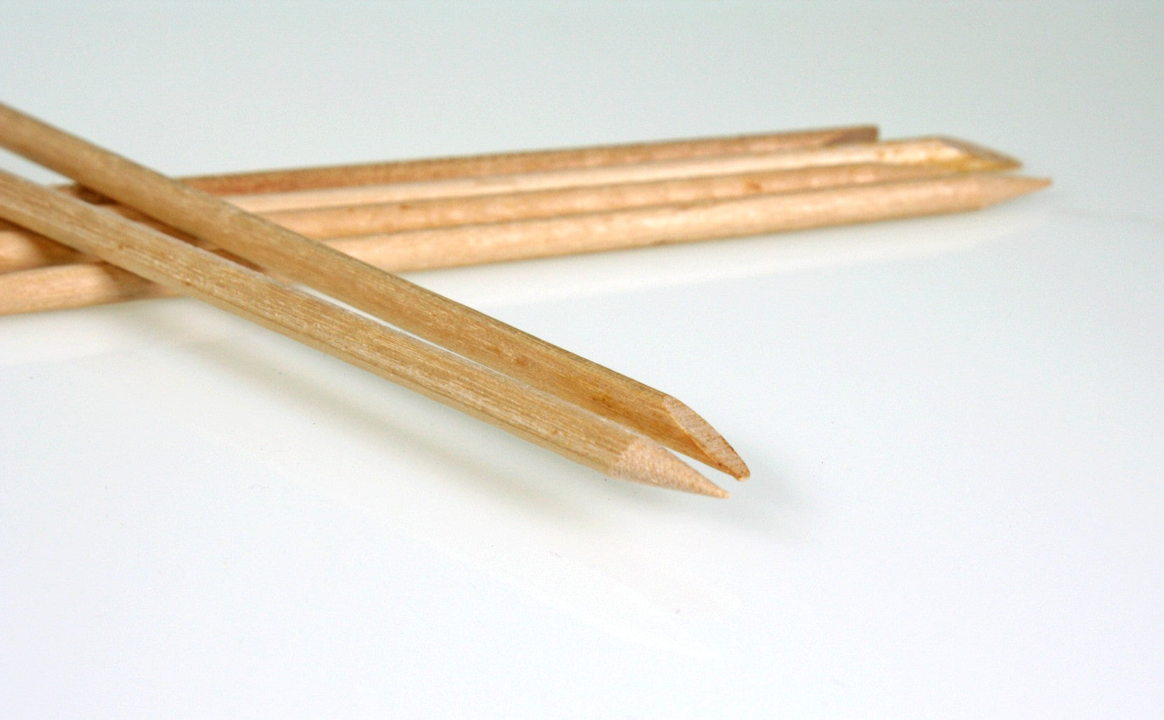 Close up of the ends of the sticks, showing each stick has one rounded and one pointy end.